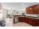 Kitchen showcasing dark cabinets and stainless steel appliances with a view to the dining area at 9047 Apache Plume Dr # D, Parker, CO 80134