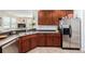 Beautiful kitchen with dark cabinets, stainless steel refrigerator, and countertop seating at 9047 Apache Plume Dr # D, Parker, CO 80134