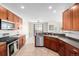 Open kitchen concept featuring dark cabinets, stainless steel appliances, and sight lines to dining area at 9047 Apache Plume Dr # D, Parker, CO 80134