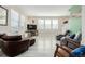 Spacious living room features updated flooring, large windows, and comfortable seating at 9047 Apache Plume Dr # D, Parker, CO 80134