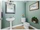Charming powder room with pedestal sink, decorative mirror, and elegant fixtures at 9047 Apache Plume Dr # D, Parker, CO 80134