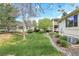 Lush backyard with green lawn and mature trees, offering a serene outdoor space for relaxation and enjoyment at 1311 S Kingston St, Aurora, CO 80012