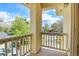 Private balcony area offering a view of the surrounding street, trees, and blue sky at 1311 S Kingston St, Aurora, CO 80012