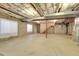 Unfinished basement with rough-in plumbing and exposed ceiling, offering potential for customization at 1311 S Kingston St, Aurora, CO 80012