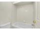Bathroom with a tiled tub and shower combination with updated fixtures at 1311 S Kingston St, Aurora, CO 80012