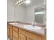 Bathroom with a double vanity, lots of light, and a large mirror at 1311 S Kingston St, Aurora, CO 80012
