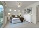 Staged bedroom with stylish furnishings, plush neutral carpet, and sliding door access to a private balcony at 1311 S Kingston St, Aurora, CO 80012