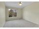 Bedroom featuring neutral carpet, a ceiling fan, and a large window with tree views at 1311 S Kingston St, Aurora, CO 80012