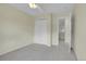 Bedroom featuring neutral carpet, a closet, and a view into the hallway at 1311 S Kingston St, Aurora, CO 80012