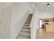 View of the stairs and the kitchen from the entrance way at 1311 S Kingston St, Aurora, CO 80012