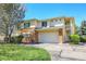 Charming two-story home featuring a two-car garage, stone facade, and manicured lawn at 1311 S Kingston St, Aurora, CO 80012
