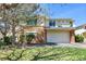 Two-story house featuring a two-car garage, stone facade, and well-maintained green lawn at 1311 S Kingston St, Aurora, CO 80012