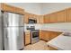 Corner kitchen with stainless steel appliances, microwave, and lots of storage in the cabinets at 1311 S Kingston St, Aurora, CO 80012