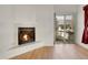 Cozy living room with tiled fireplace, hardwood floors, and access to an outdoor deck at 1311 S Kingston St, Aurora, CO 80012