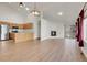 Bright living space with vaulted ceiling, fireplace, wood floors, and stainless kitchen appliances at 1311 S Kingston St, Aurora, CO 80012