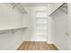 Spacious walk-in closet offers ample storage with shelves and hanging rods for optimal organization at 1311 S Kingston St, Aurora, CO 80012