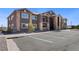Contemporary apartment building with a stone-accented facade, private balconies, and dedicated parking spaces at 875 E 78Th Ave # 70, Denver, CO 80229