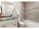 Bathroom boasts granite countertop, stylish vanity, and tiled shower over tub at 875 E 78Th Ave # 70, Denver, CO 80229
