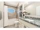 Bathroom featuring granite countertop, tiled shower, and modern finishes at 875 E 78Th Ave # 70, Denver, CO 80229