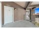 Front door of the unit with balcony and outdoor lighting at 875 E 78Th Ave # 70, Denver, CO 80229