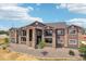 Beautiful three-story home featuring a stone facade, black iron balconies, and low maintenance landscaping at 875 E 78Th Ave # 70, Denver, CO 80229