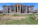 Apartment building with balconies and stone accents at 875 E 78Th Ave # 70, Denver, CO 80229