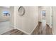 Hallway featuring wood-style floors, with views of the bedroom and doorway entrance at 875 E 78Th Ave # 70, Denver, CO 80229