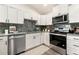 Well-equipped kitchen boasting white cabinetry, stainless steel appliances, and marble countertops at 875 E 78Th Ave # 70, Denver, CO 80229