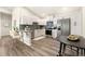 Bright kitchen features stainless appliances, stone countertops, white cabinets, and island seating at 875 E 78Th Ave # 70, Denver, CO 80229