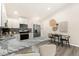 Open kitchen with stainless steel appliances, marble countertops, and dining area at 875 E 78Th Ave # 70, Denver, CO 80229