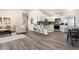 Open-concept living space flows into a modern kitchen with stainless steel appliances and white cabinets at 875 E 78Th Ave # 70, Denver, CO 80229