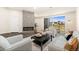 Bright living room featuring a modern fireplace, neutral furniture, and a sliding glass door to the balcony at 875 E 78Th Ave # 70, Denver, CO 80229