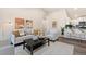 Open-concept living room with modern furnishings and seamless flow to the kitchen and dining area at 875 E 78Th Ave # 70, Denver, CO 80229