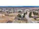 An aerial image of a neighborhood property, near a town with highway access and surrounded by greenery at 6680 E Rustic Dr, Parker, CO 80138