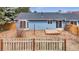 Fenced backyard featuring a small wooden deck and sliding glass door access to the home's interior at 6680 E Rustic Dr, Parker, CO 80138
