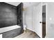 Contemporary bathroom featuring a sleek bathtub, modern shower fixtures, and stylish tile at 6680 E Rustic Dr, Parker, CO 80138