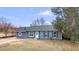 Charming single-story home boasts a fresh blue exterior, complemented by neatly trimmed black shutters and a pristine white door at 6680 E Rustic Dr, Parker, CO 80138