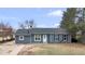 Charming single-story home with blue siding, a well-maintained lawn, and mature trees at 6680 E Rustic Dr, Parker, CO 80138