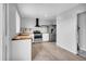 Updated kitchen boasts stainless steel appliances, white cabinets, and butcher block countertops at 6680 E Rustic Dr, Parker, CO 80138