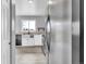 View of kitchen with stainless steel appliances, farmhouse sink, and modern white cabinets at 6680 E Rustic Dr, Parker, CO 80138