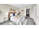 Another angle of the bright bedroom with view to the hall, contemporary decor, and a cozy rug at 8655 W Berry Ave # 202, Littleton, CO 80123