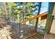 Wooded backyard view featuring stairs leading up to the elevated home at 33090 Janelle Cir, Golden, CO 80403