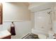 Bright bathroom features a white tub with shower and wainscoting at 33090 Janelle Cir, Golden, CO 80403