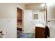 A bathroom with wainscoting features a vanity and a peek into a storage room at 33090 Janelle Cir, Golden, CO 80403