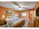 Spacious bedroom with natural light, wooden furniture, and a ceiling fan at 33090 Janelle Cir, Golden, CO 80403