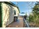 Side view of the deck with a deck box, grill, chairs, umbrella, and forest background at 33090 Janelle Cir, Golden, CO 80403