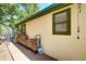Exterior view of the side of the house, with a wood pile stacked near the wall at 33090 Janelle Cir, Golden, CO 80403