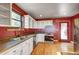 Cozy kitchen with white cabinets, wood floors, and stainless steel appliances at 33090 Janelle Cir, Golden, CO 80403