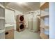 Laundry room boasts a stacked washer/dryer and two large water tanks at 33090 Janelle Cir, Golden, CO 80403