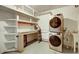 Laundry room featuring a stacked washer/dryer and a peg board wall at 33090 Janelle Cir, Golden, CO 80403